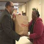man-receiving-bag-of-food-from-woman